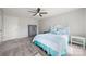 Inviting bedroom with carpet, a decorative headboard and coastal-inspired blue accents at 20338 Christofle Dr, Cornelius, NC 28031