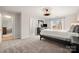 Bedroom with a neutral carpet, dark wood bed frame and ample natural light from the window at 20338 Christofle Dr, Cornelius, NC 28031