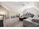 Spacious bonus room featuring a vaulted ceiling, plush carpet, and a comfortable seating area at 20338 Christofle Dr, Cornelius, NC 28031