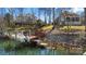Waterfront property featuring a private dock with boat, offering direct access to the lake and recreational activities at 20338 Christofle Dr, Cornelius, NC 28031