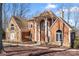 Charming home exterior with stone and wood accents, featuring a welcoming front entrance and manicured landscaping at 20338 Christofle Dr, Cornelius, NC 28031