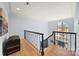 Well-lit foyer with hardwood floors and wrought iron staircase overlooking the front entrance at 20338 Christofle Dr, Cornelius, NC 28031