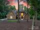 A distinguished home with stone accents and an inviting front entrance surrounded by lush greenery at 20338 Christofle Dr, Cornelius, NC 28031