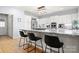 Well-lit kitchen with an island, granite countertops, barstool seating, and stainless steel refrigerator at 20338 Christofle Dr, Cornelius, NC 28031