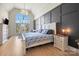 Bedroom showcasing a vaulted ceiling, large window, wood-paneled wall, and stylish decor at 20338 Christofle Dr, Cornelius, NC 28031