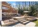 Multi-tiered backyard patio with outdoor seating and grill, creating an ideal space for entertaining and relaxation at 20338 Christofle Dr, Cornelius, NC 28031