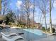 A luxurious pool and patio area overlooking a scenic lake offers ultimate relaxation at 20338 Christofle Dr, Cornelius, NC 28031