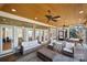 Spacious screened porch with ceiling fans, multiple seating areas and bright natural light at 20338 Christofle Dr, Cornelius, NC 28031