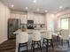 Open kitchen with white cabinets, island with seating, and stainless steel appliances at 2108 Morgan Hills Dr, Albemarle, NC 28001