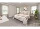 Serene primary bedroom featuring tray ceiling, plush carpeting, and natural light at 2108 Morgan Hills Dr, Albemarle, NC 28001