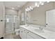 Bathroom featuring a double sink vanity with white countertops, a large mirror, and a glass enclosed shower at 2124 Clapham Ct, Charlotte, NC 28215