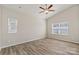 Spacious bedroom with vaulted ceilings, ceiling fan, wood-look floors and two windows for lots of natural light at 2124 Clapham Ct, Charlotte, NC 28215