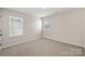 A cozy bedroom with carpet has natural light from two windows at 2124 Clapham Ct, Charlotte, NC 28215