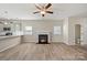 Living room with fireplace and open kitchen featuring hard surface floors and neutral paint at 2124 Clapham Ct, Charlotte, NC 28215