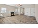 Bright living room featuring a fireplace, wood-look flooring, neutral paint, and lots of natural light at 2124 Clapham Ct, Charlotte, NC 28215