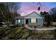 Charming single-story home featuring blue siding, black shutters, and a cozy front yard at 240 Old Limestone E Rd, York, SC 29745