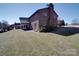 Back exterior view of brick house and manicured lawn at 257 Hickory Hill Ln, Stanley, NC 28164