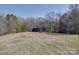 Secluded backyard featuring a shed and expansive grassy lawn at 257 Hickory Hill Ln, Stanley, NC 28164