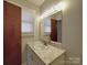 Bathroom showcasing a marble vanity, large mirror, and updated sink fixtures at 257 Hickory Hill Ln, Stanley, NC 28164