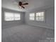 Bedroom featuring neutral carpet, a ceiling fan, and windows offering natural light at 257 Hickory Hill Ln, Stanley, NC 28164