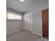 Bedroom featuring neutral walls, carpet, large window, and closet space at 257 Hickory Hill Ln, Stanley, NC 28164