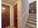 Hallway showing a staircase with carpet and doors at 257 Hickory Hill Ln, Stanley, NC 28164