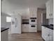 Spacious kitchen with white cabinets, laminate flooring and stainless steel refrigerator at 257 Hickory Hill Ln, Stanley, NC 28164