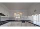 Galley kitchen showing white cabinets, dark countertops, and stainless steel appliances at 257 Hickory Hill Ln, Stanley, NC 28164