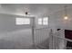 Bright living room features neutral carpeting, a ceiling fan, and staircase at 257 Hickory Hill Ln, Stanley, NC 28164