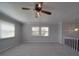 Living room with a ceiling fan and large windows offering ample natural light at 257 Hickory Hill Ln, Stanley, NC 28164