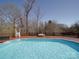 Backyard pool and deck area with a lounge chair and trees in the background at 257 Hickory Hill Ln, Stanley, NC 28164