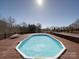 Backyard pool and deck area with a lounge chair and trees in the background at 257 Hickory Hill Ln, Stanley, NC 28164