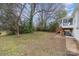 Spacious backyard with mature trees and a glimpse of the home's back deck at 3504 Meredith Ave, Charlotte, NC 28208