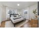 Cozy bedroom featuring hardwood floors, neutral color scheme, and bright natural lighting at 3504 Meredith Ave, Charlotte, NC 28208