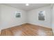 Empty bedroom with hardwood floors, natural light, neutral walls and ready for your personal touch at 3504 Meredith Ave, Charlotte, NC 28208