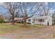 Charming one-story white brick house with a wide front lawn, perfect for outdoor activities at 3504 Meredith Ave, Charlotte, NC 28208