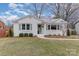 Charming one-story white brick home with a well-manicured lawn and green shutters at 3504 Meredith Ave, Charlotte, NC 28208