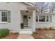 Inviting front porch with a green door, white brick columns, and decorative plants at 3504 Meredith Ave, Charlotte, NC 28208