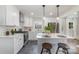 Beautifully updated kitchen with stainless appliances, white cabinets, an island and pendant lighting at 3504 Meredith Ave, Charlotte, NC 28208