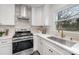 Close up of the modern kitchen with stainless steel appliances, designer backsplash and gold hardware at 3504 Meredith Ave, Charlotte, NC 28208