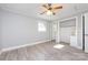 Bedroom features a ceiling fan, two windows, and a closet for optimal comfort and storage at 4211 Little Mountain Rd, Gastonia, NC 28056