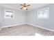 Bedroom with gray walls, light-colored wood-look floors, and a ceiling fan with windows for natural light at 4211 Little Mountain Rd, Gastonia, NC 28056