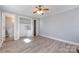 Bedroom with open closet, adjacent doorway, and wood-look floors at 4211 Little Mountain Rd, Gastonia, NC 28056