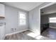 Bright kitchen area with light gray walls, wood-look flooring and access to the upper level at 4211 Little Mountain Rd, Gastonia, NC 28056