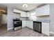 Modern kitchen featuring white cabinets, stainless steel appliances, granite counters, and wood-look floors at 4211 Little Mountain Rd, Gastonia, NC 28056