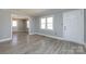 Bright living room featuring gray walls, white trim, and durable light gray wood-look flooring at 4211 Little Mountain Rd, Gastonia, NC 28056