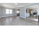 Large living area with light gray walls and wood-look flooring, connecting to the kitchen at 4211 Little Mountain Rd, Gastonia, NC 28056