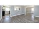 Open-concept layout with light gray wood-look flooring connecting the living room and kitchen at 4211 Little Mountain Rd, Gastonia, NC 28056