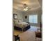 Inviting main bedroom with a tray ceiling, a ceiling fan, and a large window at 422 Drake Ln, Salisbury, NC 28146