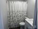 A full bathroom with shower curtain, and modern vanity that complements the neutral color scheme at 424 20Th Ne Ave, Hickory, NC 28601